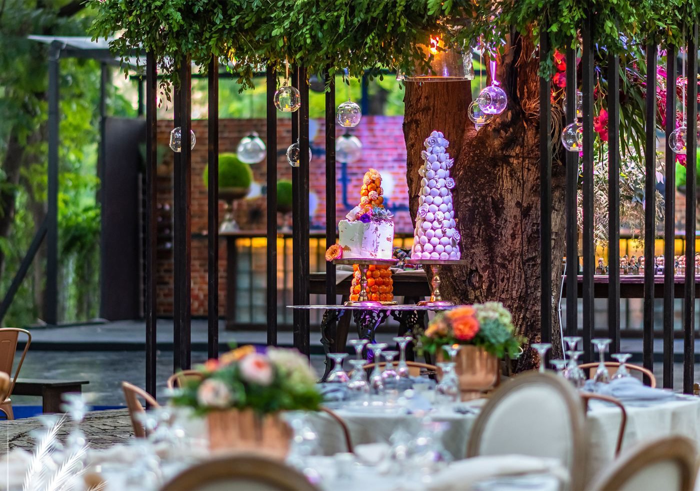 Garden reception with a tiered cake and floral centrepieces